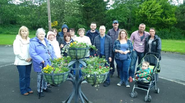 Housing Executive and Council staff put the finishing touches to the planters at Columbia Park, with JP McCloskey.