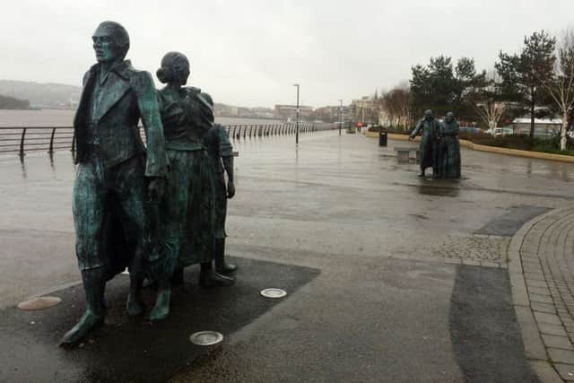 Derry artist, Éamonn O'Doherty's 'The Emigrants' sculpture along the quay.