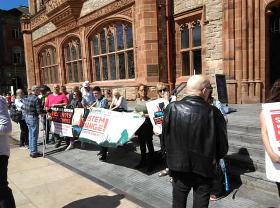 Welfare Reform protesters pictured outside the meeting in the Guildhall.