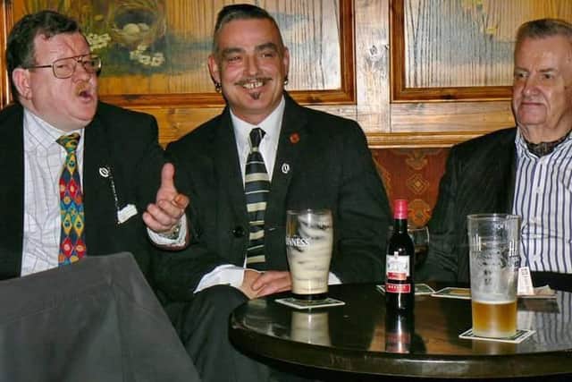 Ivan (seated right) with his frequent driver, the late Tom Timoney, in happier times enjoying Fionnbarra in full flow delivering a few of his countless humorous real-life local sagas.
