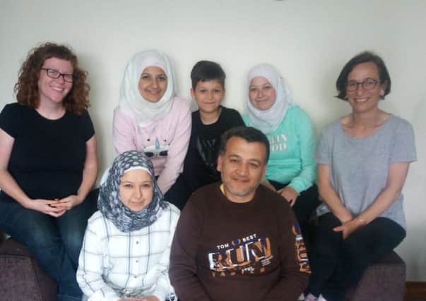 Feras and Asmaa (front), their family Sedra, Adel and Shaimaa, with Siobhan Shiels, Inishowen Together and Gayle Green.
