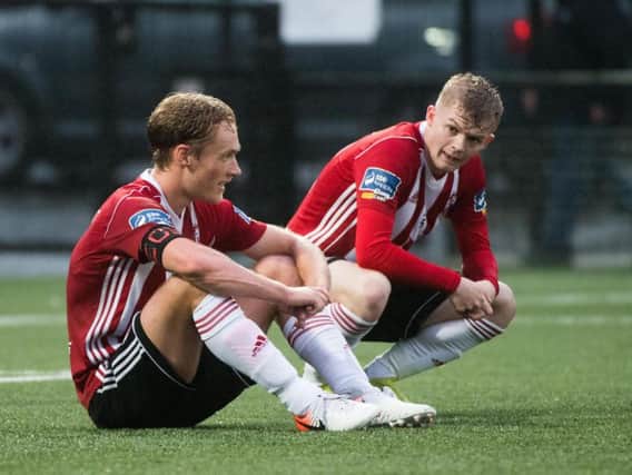 Derry's Greg Sloggett and Aidy Delap wonder how the Candy Stripes failed to find the back of the net against UCD.