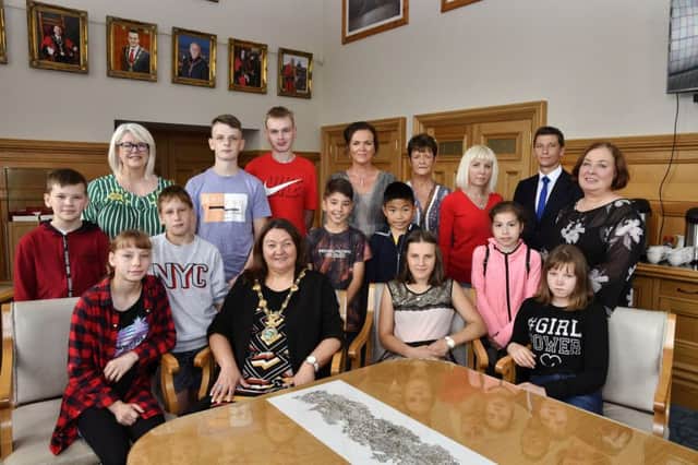 The Mayor, Councillor Michaela Boyle pictured with children from Chernobyl and host familes when she hosted a recent reception in the Guildhall. Included is Alderman Ryan McCready. DER2919-140KM