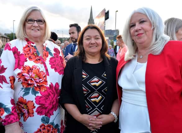 Cathy Healey, on the left and Christine Robson daughters of the late Sammy Devenny pictured with Mayor of Derry City and Strabane, Colr Michaela Boyle, at his memorial on William Street on Wednesday evening last.  DER2919GS-032