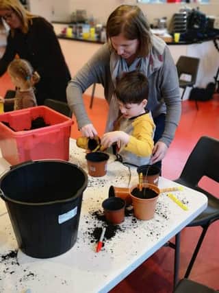 Planting their tree seeds are Denise and Charles from the ESCAPE Social Group at Eglington Community Hall.