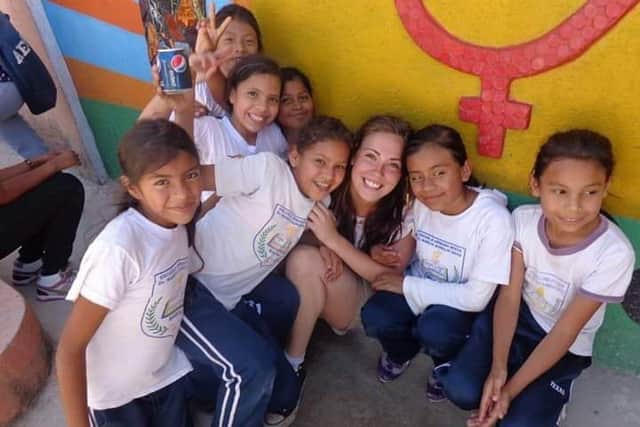 Carol-Anne pictured with some local children during her time volunteering with ICS in Honduras in 2013.