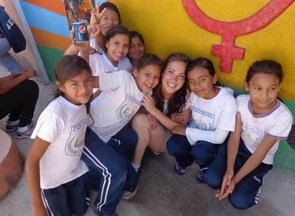 Carol-Anne pictured with some local children during her time volunteering with ICS in Honduras in 2013.