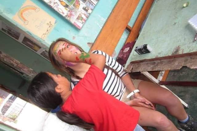 Carol-Anne having her face painted by one of the local children. During her ten weeks in Honduras the volunteers visited orphanages to play with the children.
