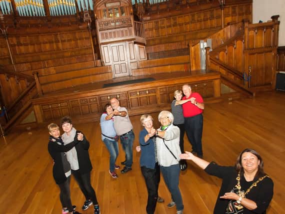The Mayor of Derry City and Strabane District Council, Michaela Boyle pictured enlisting the help of some German tourists visiting the city to launch her new series of tea dances at the Main Hall, Guildhall on Wednesday morning.