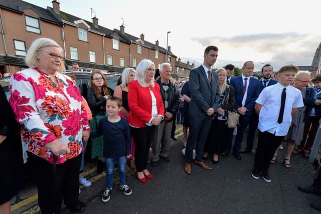 Children, grandchildren and great grandchildren of the late Sammy Devenny hold a minutes silence at his memorial on William Street on Wednesday evening last.  Mr Devenny died after he was attacked by members of the RUC, in his home, 50 years ago. DER2919GS-031