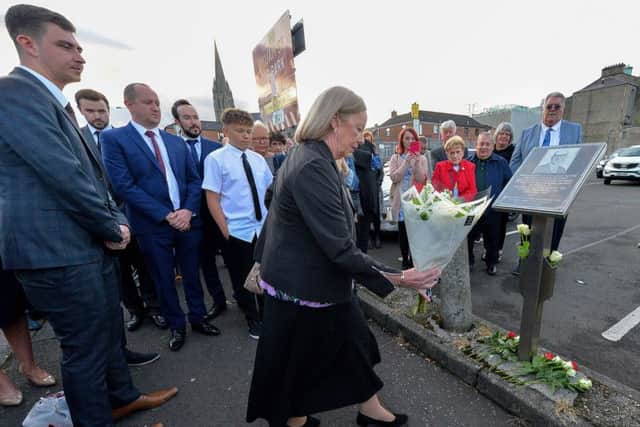 Sammy Devennys daughter Mena places flowers at his memorial on William Street on Wednesday evening last.  Mr Devenny died after he was attacked by members of the RUC, in his home, 50 years ago. DER2919GS-030