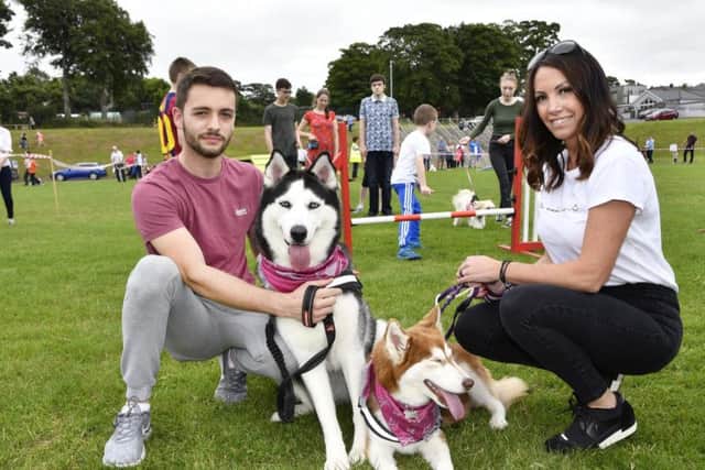 Jordan and Julie Upton pictured with Storm and Summer during a previous Pooches in the Park event held in St. Columb's Park by the Rainbow Rehoming Centre. DER3018-107KM