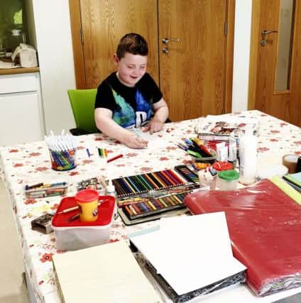 Young Adam with Christina enjoying art therapy at the Macmillan Health and Well Being Campus, Altnagelvin Hospital