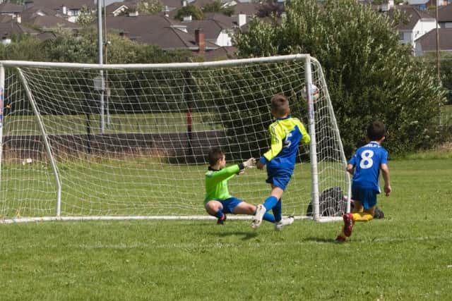 GOAL!. . . .Glen Rovers' Dylan Curley plants this shot in the top corner past the helpless Eglinton Eagles goalkeeper in the O'Neills Foyle Cup Under 9 clash at Templemore Sports Complex on Monday.