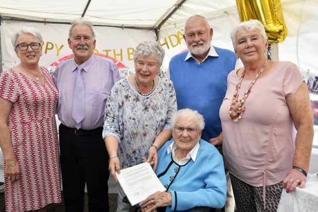 Elizabeth 'Lily' Graham, who celebrated her 100th birthday with a party at Lenamore on Tuesday, pictured with her children, from left, Rosemary, Edwyn, Jennifer, Kenneth and Geraldine. Lily, who is pictured holding her letter from President Michael D Higgins, was born on the 23rd of July 1919. DER3019-124KM