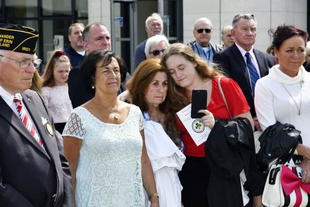 Emotional scenes as family members watch the ceremony in the grounds of Foyle College on Tuesday. DER3119-104KM