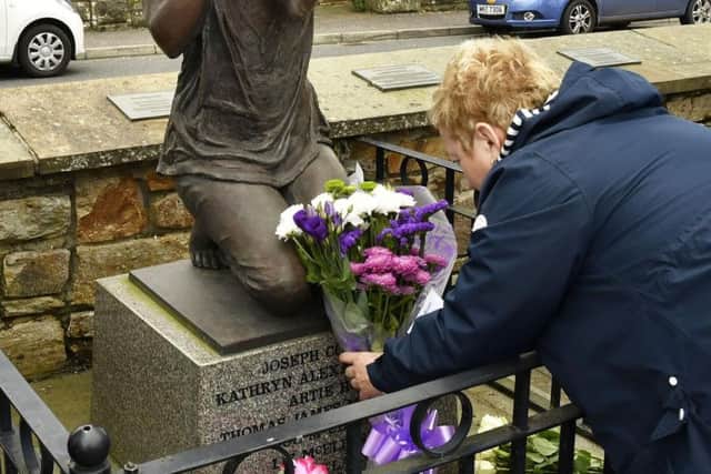 Joyce Galbraith lays a wreath at the Claudy memorial on Wednesday.