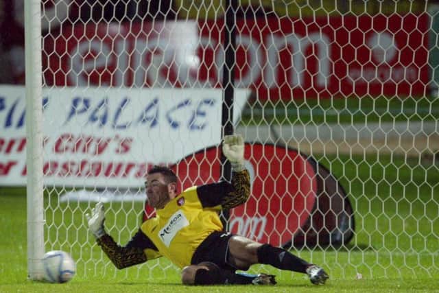 Derry's Patrick Jennings saves a spot kick in the penalty shoot out.