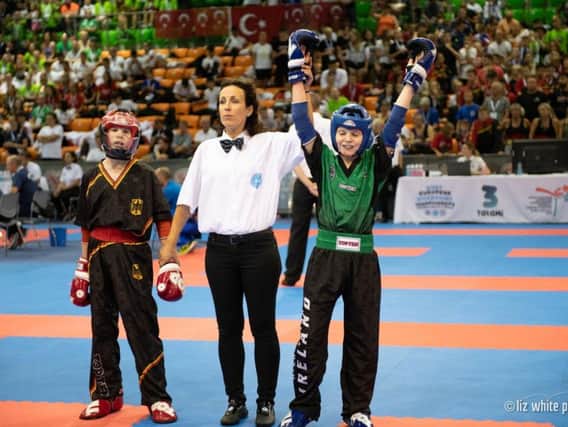 Kyle Moore has his hand raised in victory in the final of the European Junior Championships in Hungary.