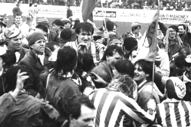 Krstic celebrates with the large travelling Derry City support after his hat-trick sealed a 3-1 win over Cork in the FAI Cup in 1986..