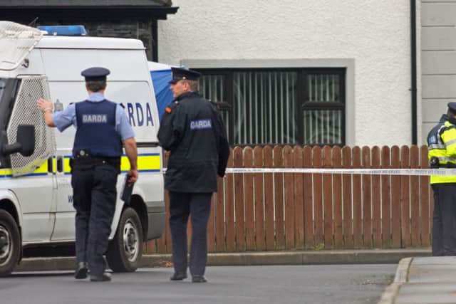Gardai officers pictured at the scene of the fatal shooting of Andrew Allen at Links View Park, Lisfannon in 2012. 1402JM06