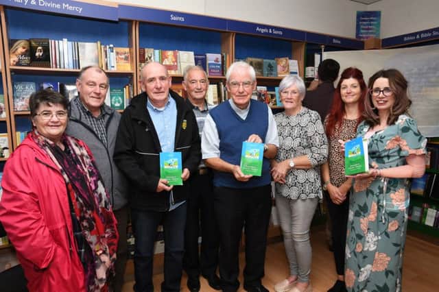 Fr Neal Carlin, fourth from right, pictured at the launch of his book 'Favourite Celitc Saints, A Simple Book of Prayers' in Veritas on Wednesday night with, from left, Noeleen Tynan, Peter Tynan, Aodan Carlin, Denis McGaughey, Celine McGaughey, Sinead Rainey and Jacklyn Roberts. DER3719-132KM