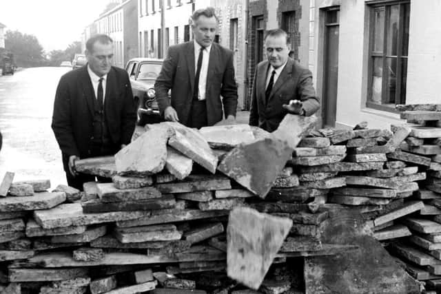 September 1972... Phil O'Donnell, Paddy 'Bogside' Doherty and Micheal Canavan, of the Derry Citizens' Defence Association (DCDA) help demolish a barricade at the top of Creggan Hill.