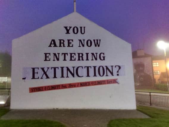 Free Derry Corner has been changed to carry an apocalyptic warning over climate change and threat facing the planet.