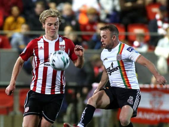Derry City's Greg Sloggett tussles with Bohemians Keith Ward.