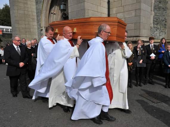 Priests from the Derry Diocese carry the coffin of Bishop Samus Hegarty from St Eugenes Cathedral, after Requiem Mass  yesterday afternoon, for burial in the cathedral grounds.