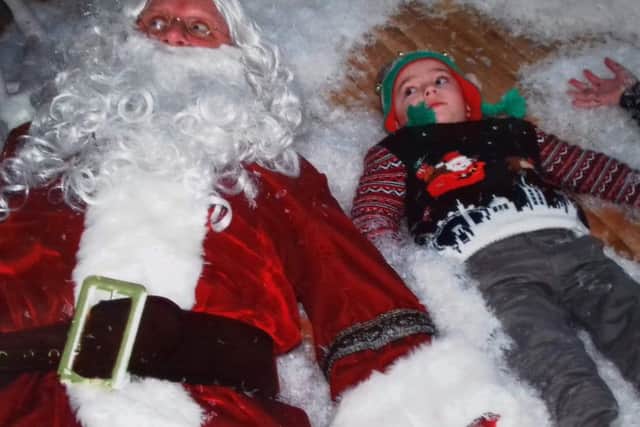 A young child having fun with Santa at one of Enchanted Events NI's grottos in Belfast.