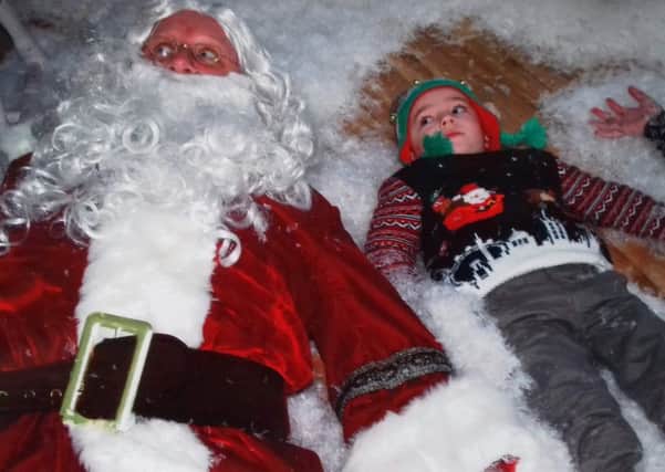 A young child having fun with Santa at one of Enchanted Events NI's grottos in Belfast.