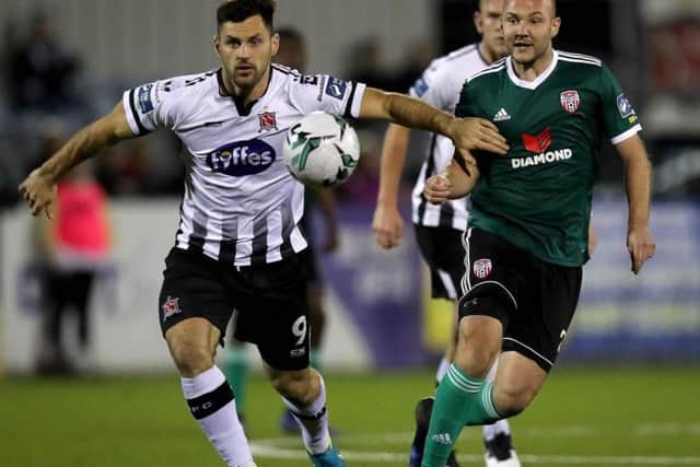 Dundalk striker Pat Hoban holds off Derry City midfielder Grant Gillespie.