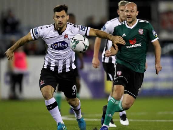 Dundalk striker Pat Hoban holds off Derry City midfielder Grant Gillespie.