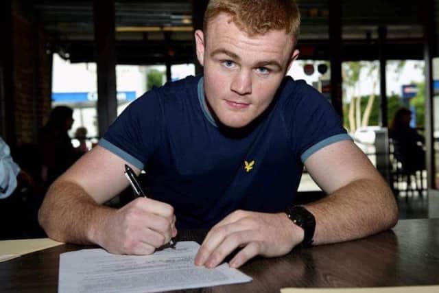 Brett McGinty pictured signing pro terms in LA last month.