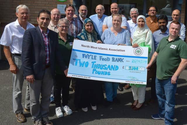 Members of the North West Islamic Association present a cheque for £2000 to James McMenamin, on the right manager of the Foyle Foodbank earlier this year. Included in the photograph are staff from the foodbank, The donation was the proceeds from the Ramadan fast challenge.   DER2619GS-055