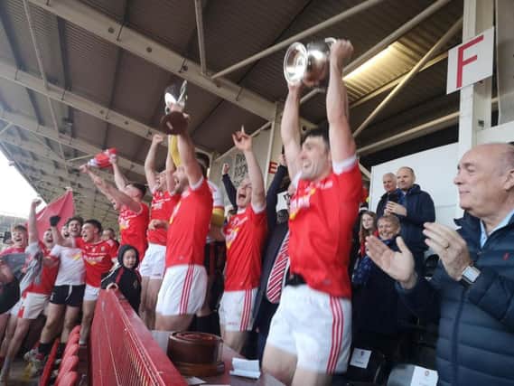 Magherafelt captain Danny Heavron lift the John McLaughlin Cup high above his head after the Rossas defeated Glen to win their first Derry senior crown since 1978
