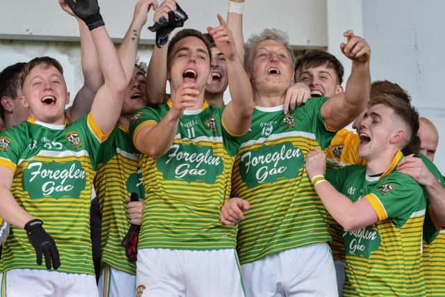 Kevin Dunne (No. 11) and Ciaran McFeely (No. 19) lead the Foreglen celebrations in Celtic Park on Sunday. DER4319GS 009