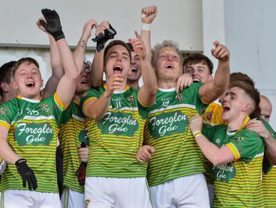 Kevin Dunne (No. 11) and Ciaran McFeely (No. 19) lead the Foreglen celebrations in Celtic Park on Sunday. DER4319GS 009