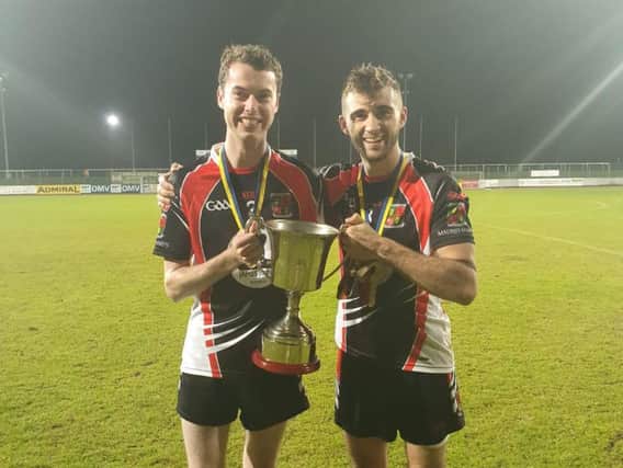 Madrid Harps' pair Jason Mallon and Eoghan Kelly pictured holding the European Senior Cup, which they secured in Vienna.