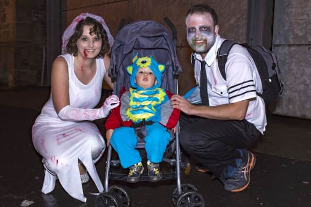 Ciaran Robinson with his mum Becky and dad Aidan pictured at last year's Halloween night celebrations in the city centre. (Picture George Sweeney) DER4418GS020