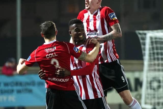 Junior celebrates his hat-trick with David Parkhouse and Ciaran Coll.