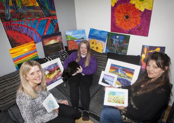Tory McNeill pictured at her Waterside home with her mum (left) and tutor surrounded by some of the artwork which will be on display at two exhibitions next month in the city - one at The Waterside Theatre, starting Friday, 8th November and the other at the Garden of Reflection, Bishop Street starting Monday, 18th November. (Photos: JIm McCafferty Photography)