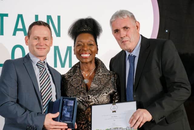 John Quinn (left), Derry City and Strabane District Council Streetscape Manager, pictured with Floella Benjamin and William Ferguson, Grounds Maintenance Supervisor, receiving the Britain in Bloom Small City award. (RHS / Richard Dawson)