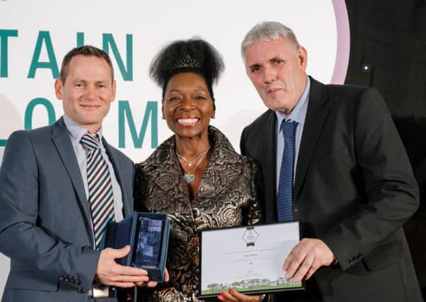 John Quinn (left), Derry City and Strabane District Council Streetscape Manager, pictured with Floella Benjamin and William Ferguson, Grounds Maintenance Supervisor, receiving the Britain in Bloom Small City award. (RHS / Richard Dawson)