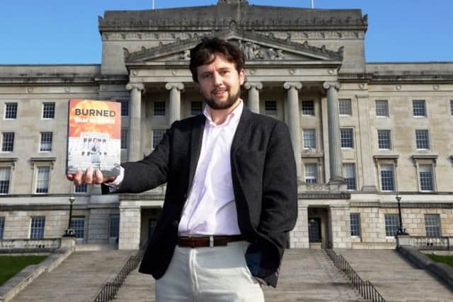 Sam McBride, author of 'Burned', pictured with his new book at Stormont.