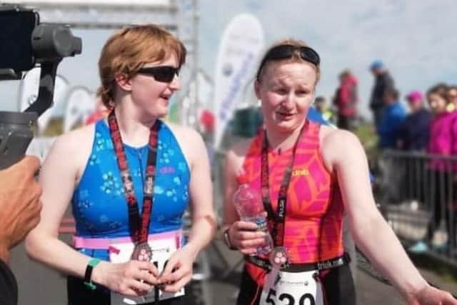 Chloe (left) and Judith Mac Combe chat after a para-triathlon.