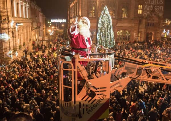 Santa arrives over a crowd of thousands from Derryâ¬"s Walls as he  to switched on the Christmas Lights in Guildhall Square. Picture Martin  McKeown. Inpresspics.com. 22.11.18