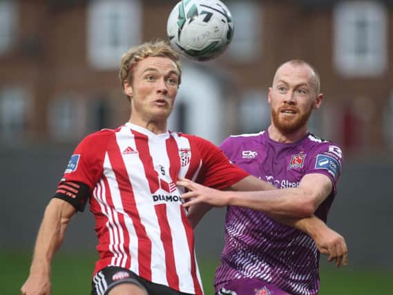 Former Derry City vice captain, Greg Sloggett, pictured in action against Dundalk midfielder, Chris Shields, recently signed a two year deal with the league champions.