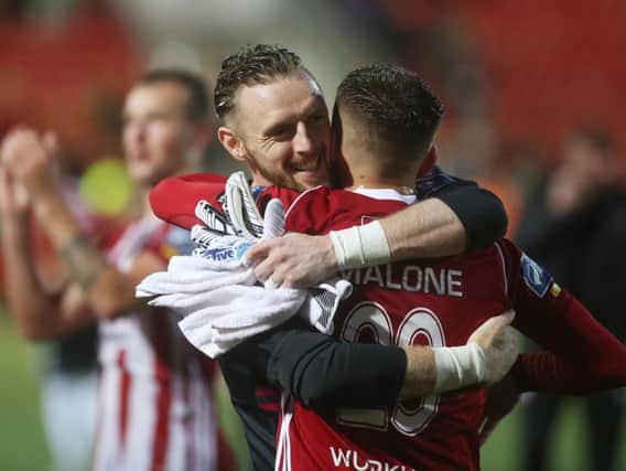 Peter Cherrie celebrates with Jack Malone last season.